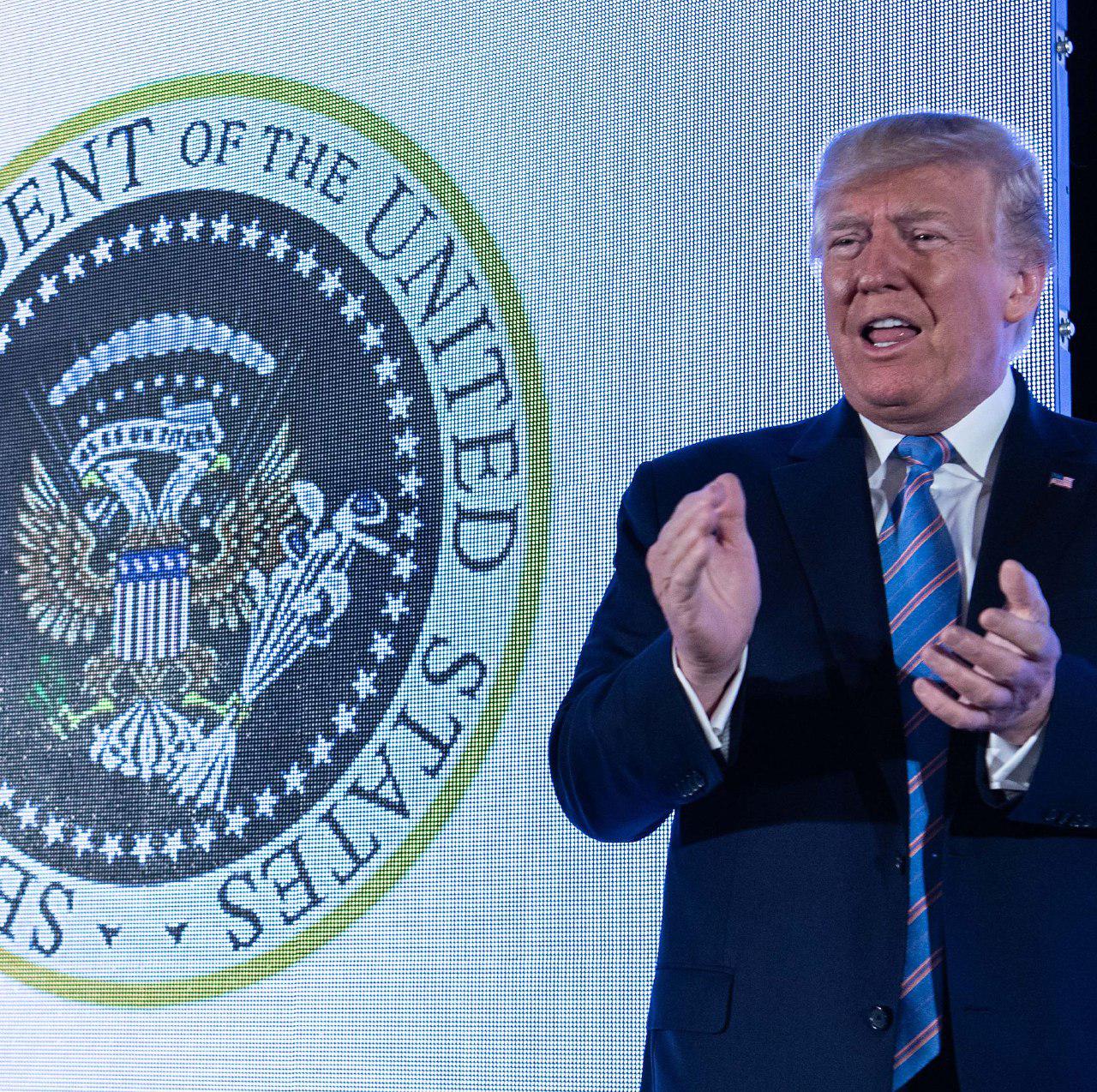 "45 Is a Puppet" Trump Appears In Front Of Doctored Presidential Seal Resembling Russian Coat Of Arms