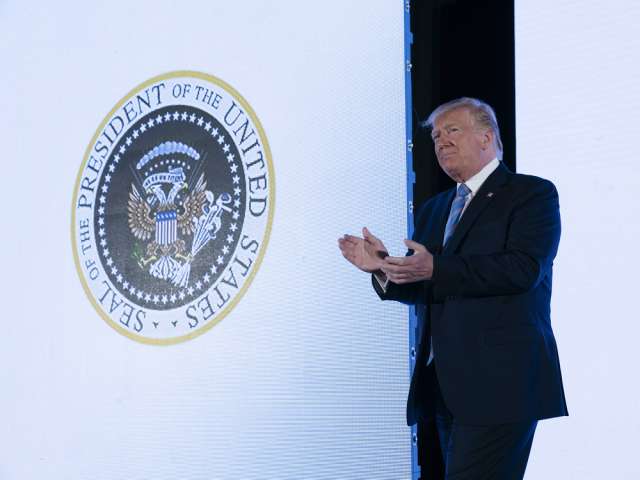 "45 Is a Puppet" Trump Appears In Front Of Doctored Presidential Seal Resembling Russian Coat Of Arms